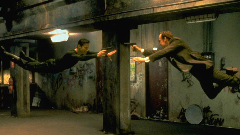Neo (Keanu Reeves) and Agent Smith (Hugo Weaving) fighting each other within the Matrix