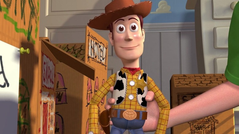 Cowboy toy Woody (Tom Hanks) pretending to be inanimate while Andy plays with him in "Toy Story"