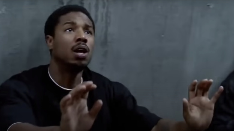 Michael B. Jordan with hands up
