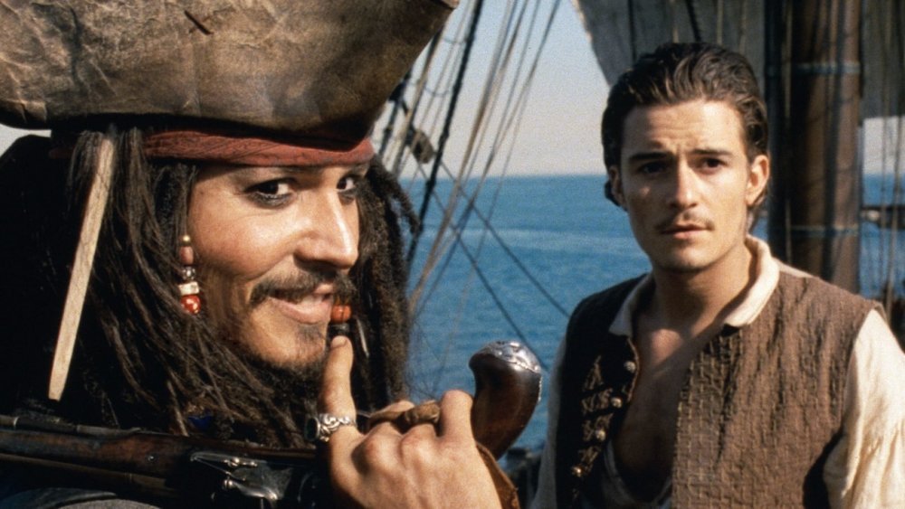 Johnny Depp as Jack Sparrow and Orlando Bloom as William Turner in Pirates of the Caribbean: Curse of the Black Pearl