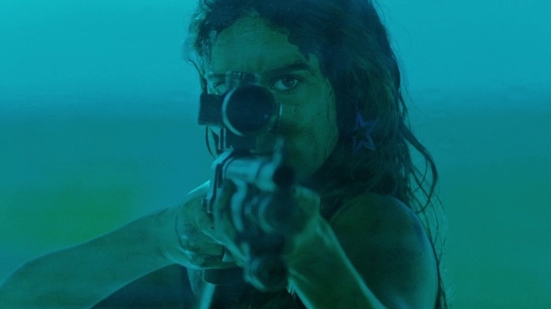 Jen holding sniper rifle