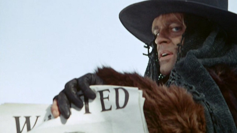 Klaus Kinski holding wanted poster