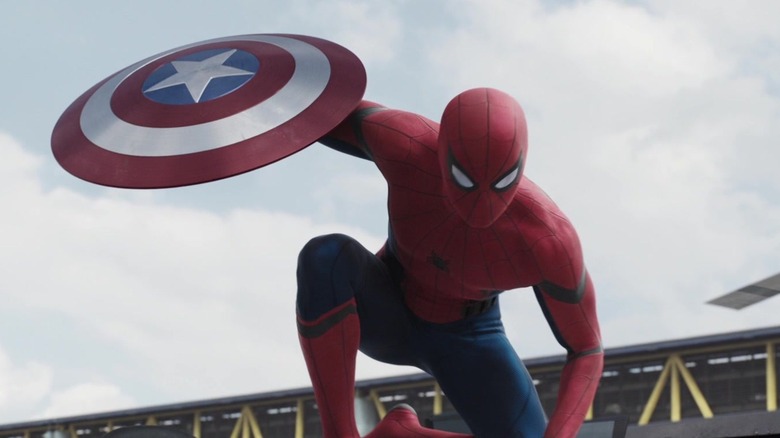 Spider-Man holding Cap's shield