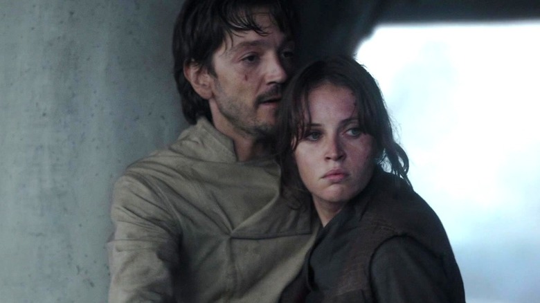 Cassian Andor holding Jyn Erso in Rogue One: A Star Wars Story