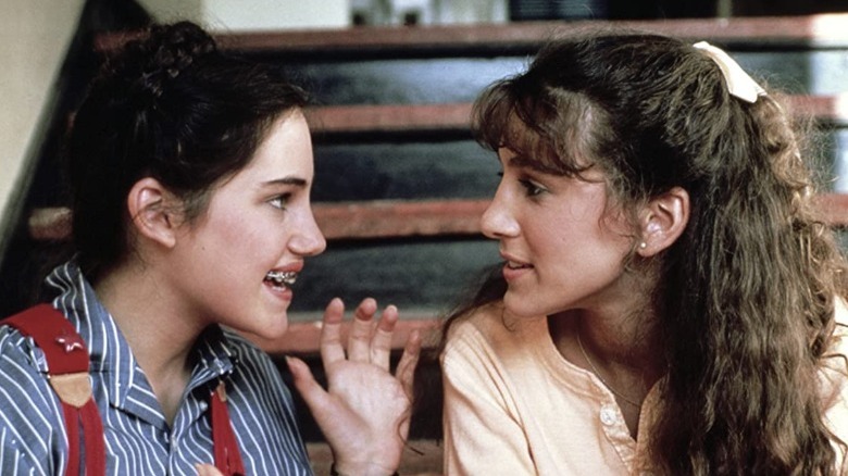 Teenage girls looking at each other