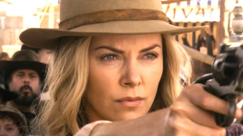 Charlize Theron as Anna pointing gun