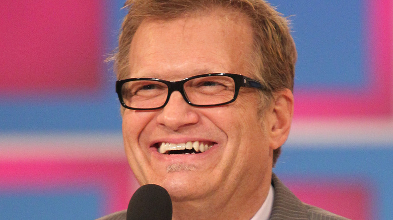 Drew Carey smiling with microphone 