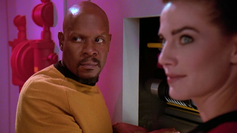 Sisko and Dax look over their shoulders