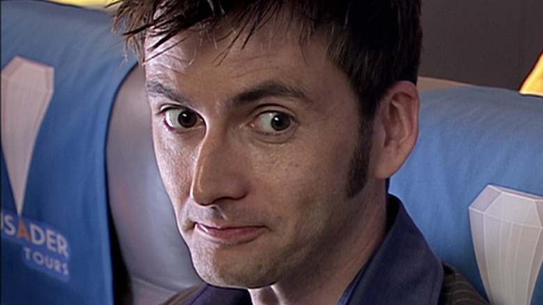 Tenth Doctor smirks on airplane