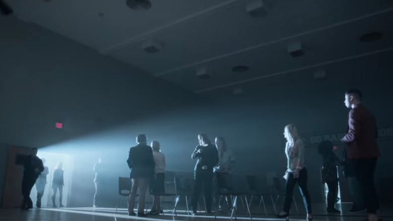 People standing in dark hall