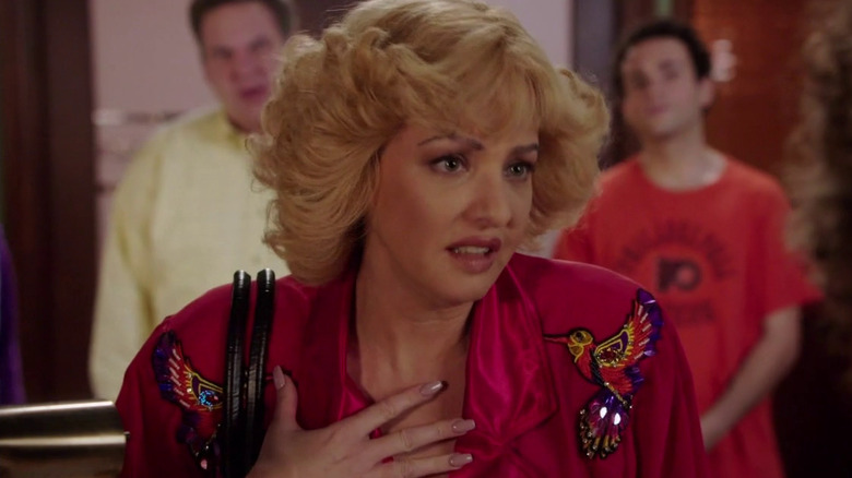 Beverly holds her hand to her chest
