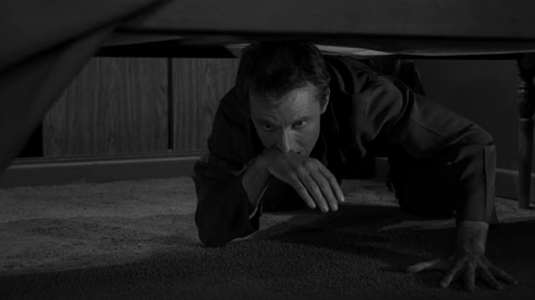 Chris Miller looks under bed