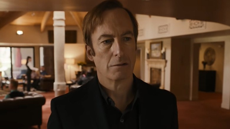 Jimmy McGill ponders in black suit
