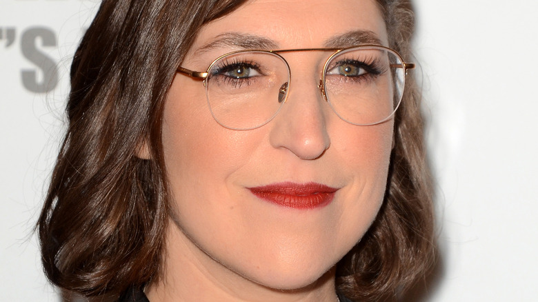 Mayim Bialik wearing glasses red lipstick