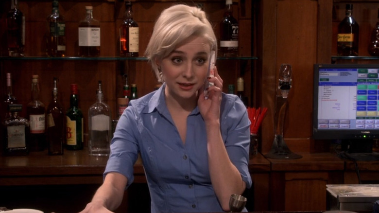 Claire talking on the phone while bartending