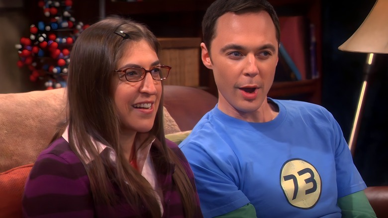 Amy Farrah Fowler and Sheldon Cooper sitting smiling