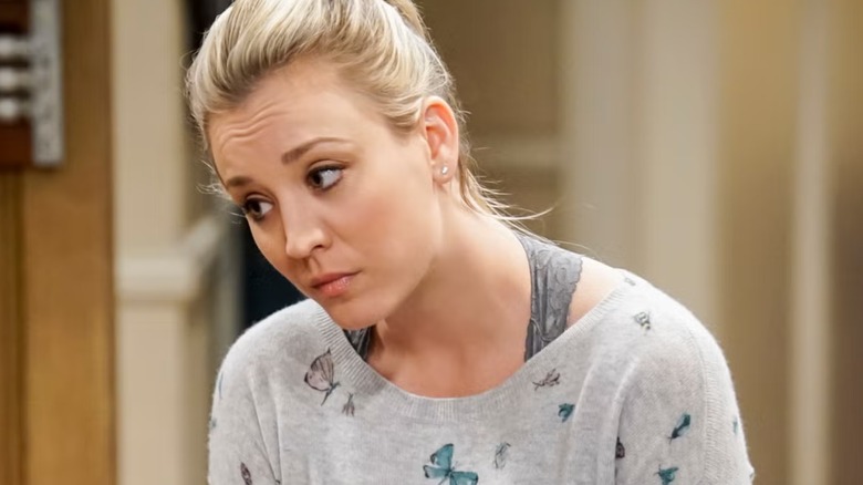 Penny leaning over looking concerned