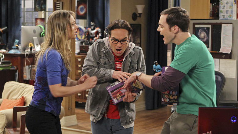 Sheldon and Leonard fighting over an action figure with Penny looking on in The Big Bang Theory