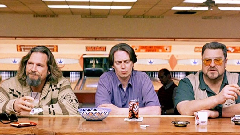 The Dude, Donnie, and Walter sitting at the bowling alley bar