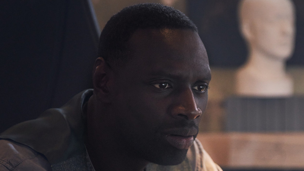Omar Sy staring intently