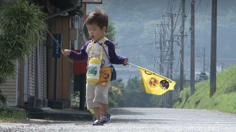 Two-year-old walking down the street