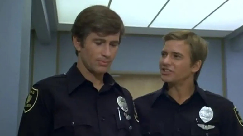 Foley and Burdick walk down a hall