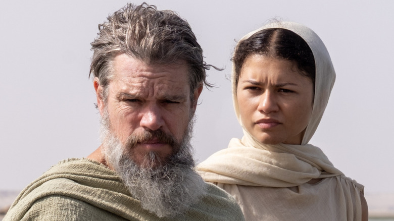 Odysseus and Athena stand on the shore in 