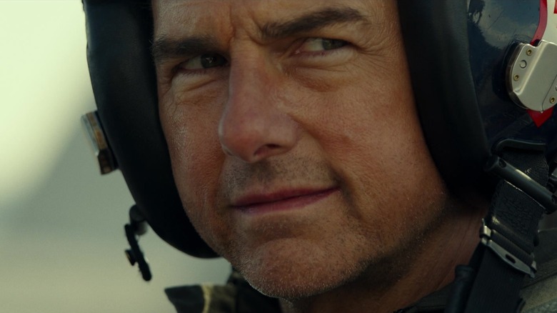 Tom Cruise as Maverick smiling wearing helmet