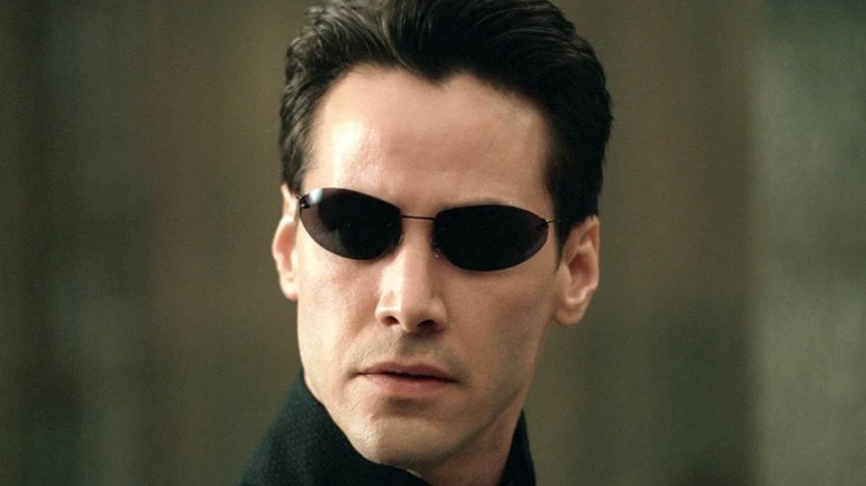 Neo in his signature sunglasses