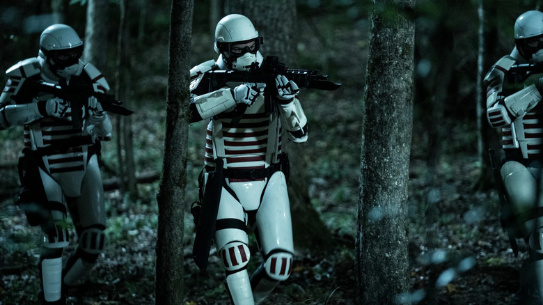 Commonwealth Army soldiers running through woods