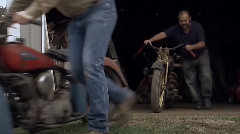 Zane and Frank pushing motorcycles