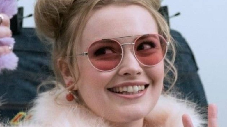 Slaxx girl smiling with pink sunglasses on