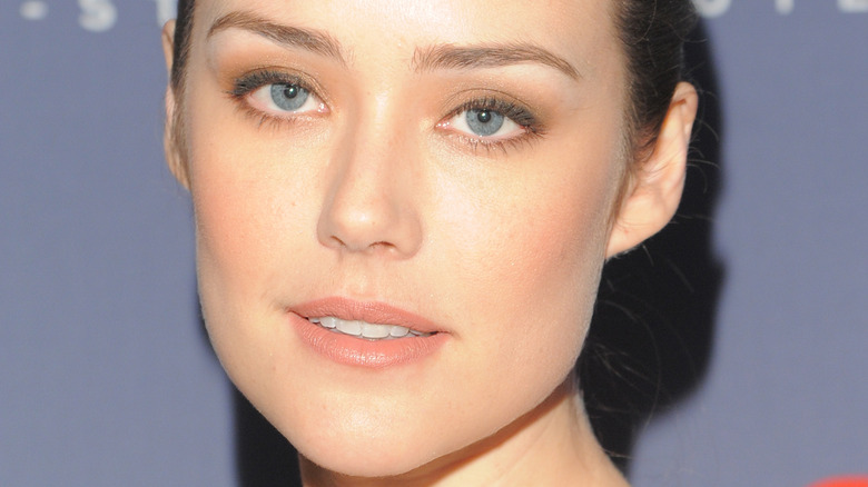 Megan Boone smirks at an event 