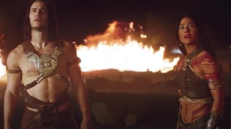 John Carter and Dejah Thoris stand in front of flames in "John Carter" (2012)