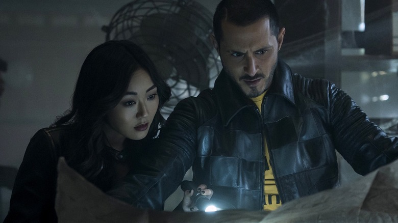 Kimiko and Frenchie inspecting papers with a flashlight on The Boys