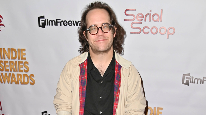 Ely Henry wearing glasses and smiling