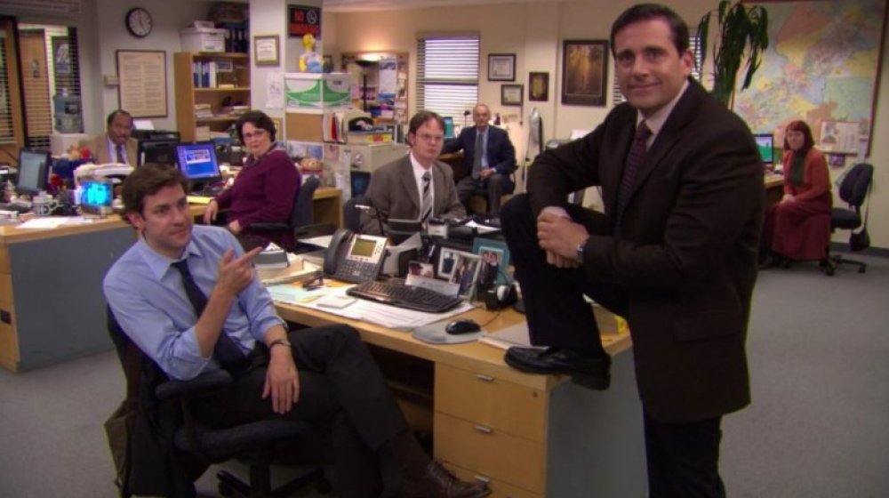 The Office cast, Steve Carell standing with his foot on Jim's desk