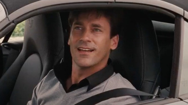 Bridesmaids Jon Hamm smiles from car