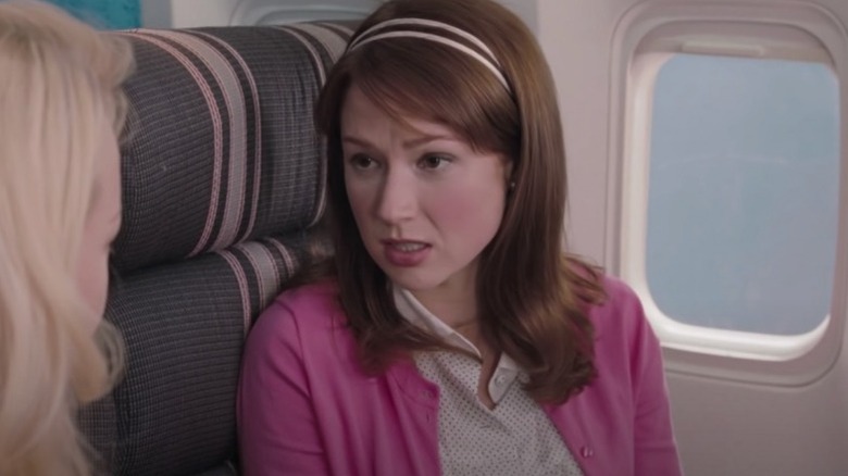 Bridesmaids Becca wears pink cardigan on plane