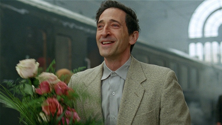 László Tóth smiling and holding flowers in 