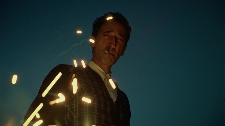 László Tóth smokes as sparks fly in "The Brutalist" (2024)