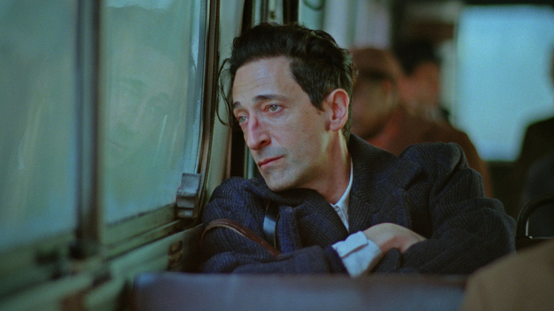 László Tóth sitting on a train in "The Brutalist" (2024)
