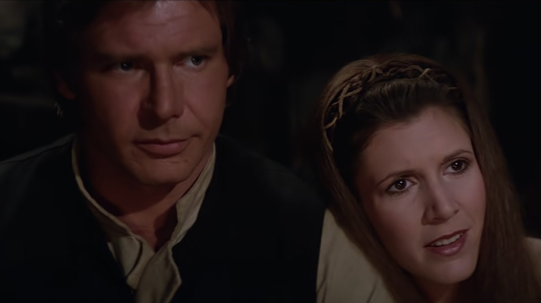 Han Solo and Princess Leia listening