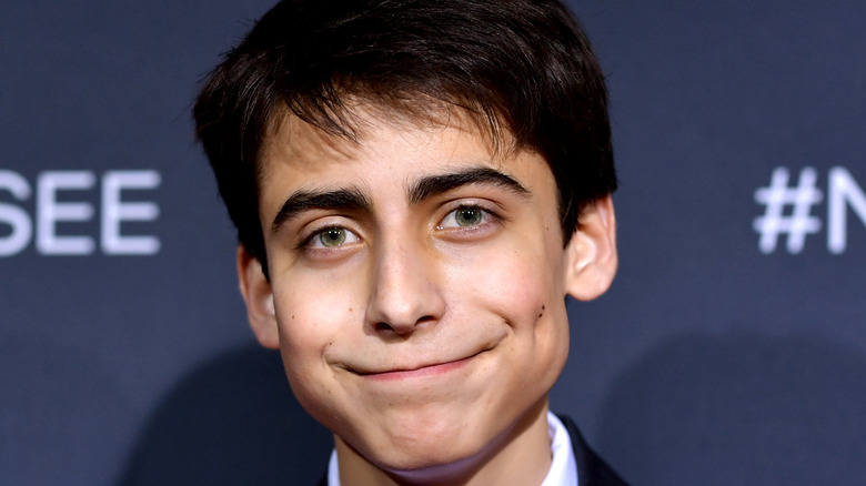 Aidan Gallagher smiling at Netlix press event