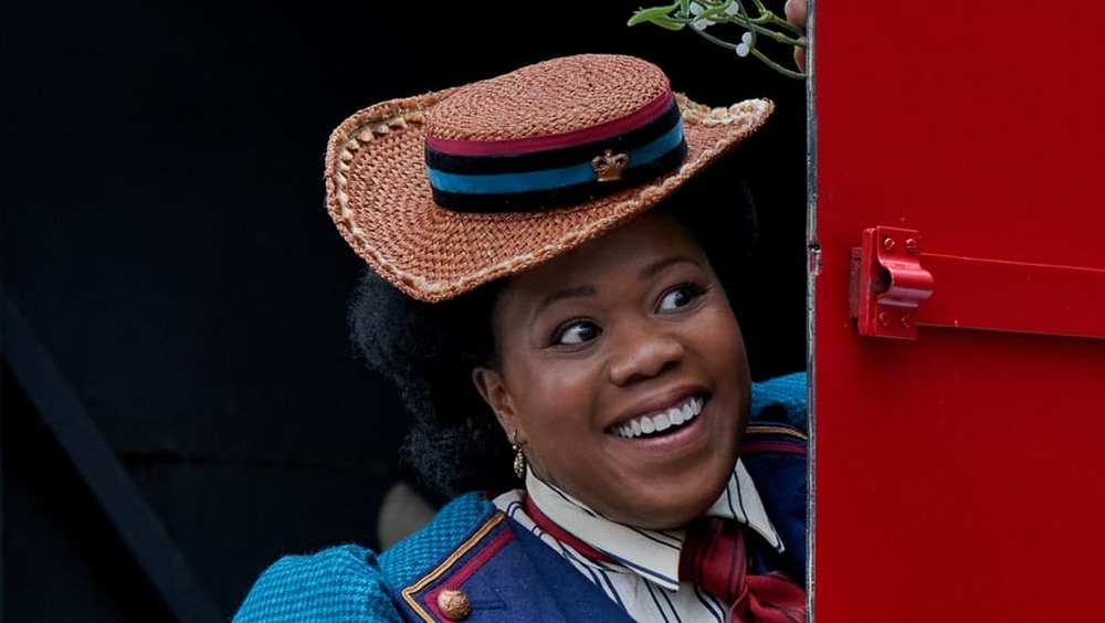 Lisa Davina Phillip behind the door of a mail truck