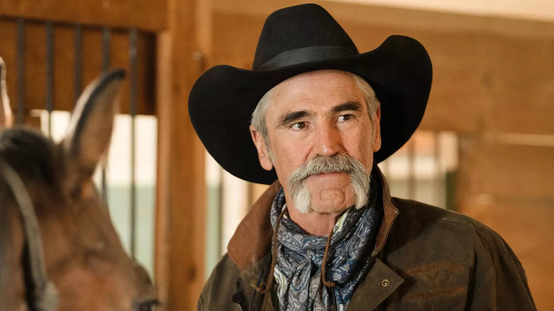 Lloyd Pierce standing in front of a horse in Yellowstone