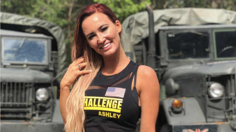 Ashley posing by trucks