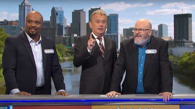 Pat Sajak and contestants