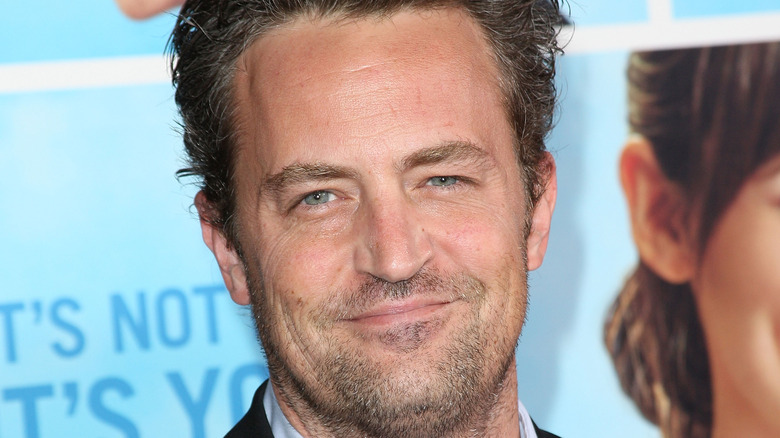 Matthew Perry grinning stubble