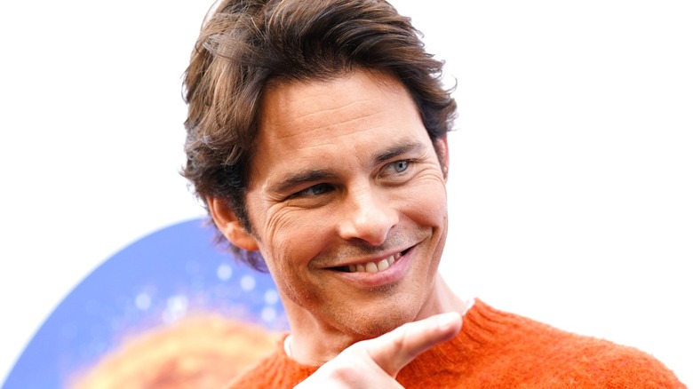 James Marsden wearing an orange sweater